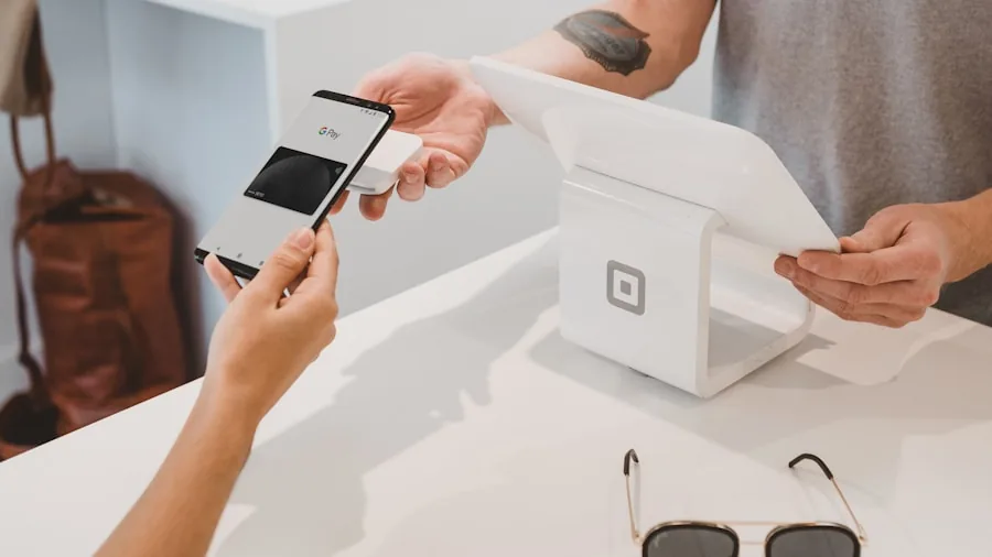 Person comparing phone options while shopping, considering affordable technology purchases