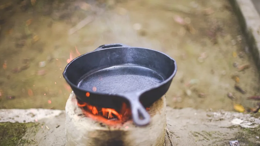 The %product_count% Best Dutch Ovens 2 Person cooking with cast iron cookware on stovetop, demonstrating heat distribution and cooking technique