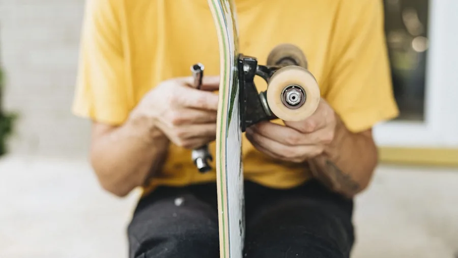 Person customizing skateboard components on wooden workbench in natural light