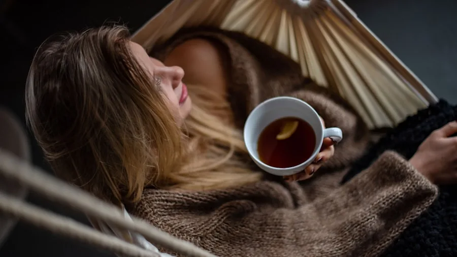 Person enjoying a cup of tea in natural morning light, relaxed and calm