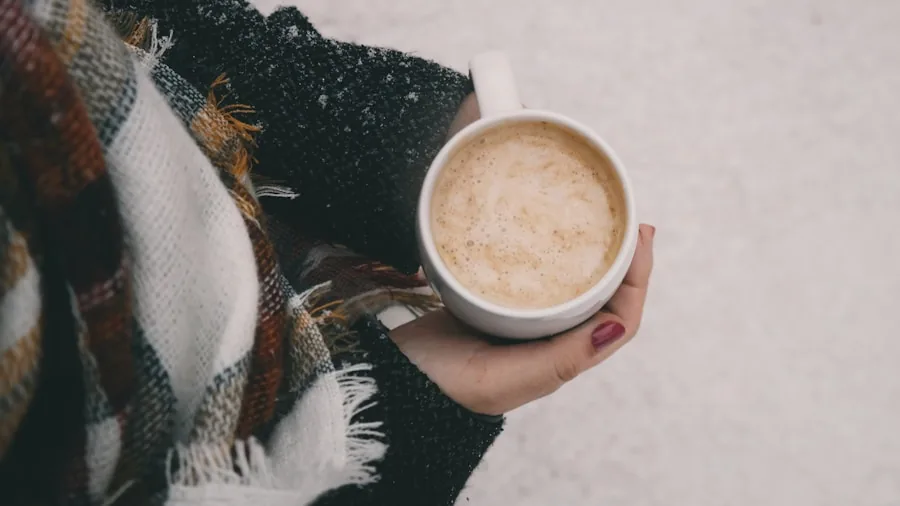 Person enjoying a hot drink while traveling in cold weather, demonstrating thermal insulation performance