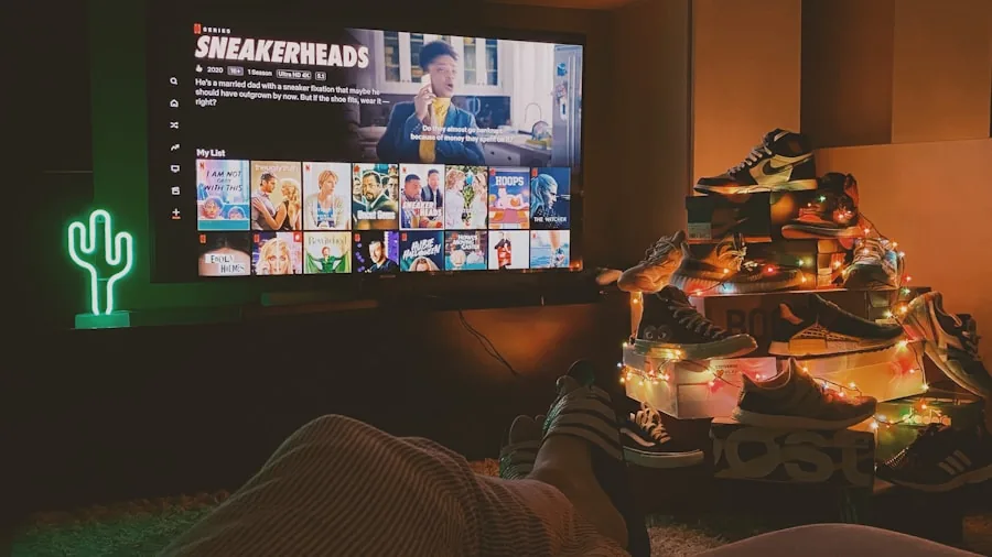 The %product_count% Best 65 Inch TVs 2 Person enjoying a movie in a dark room, experiencing immersive home entertainment
