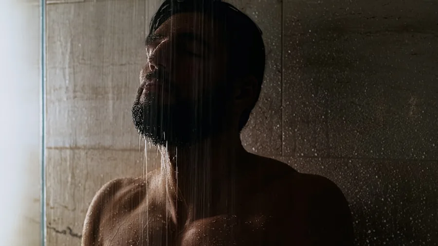 Person enjoying a relaxing shower with water cascading, demonstrating daily skincare and hygiene routine