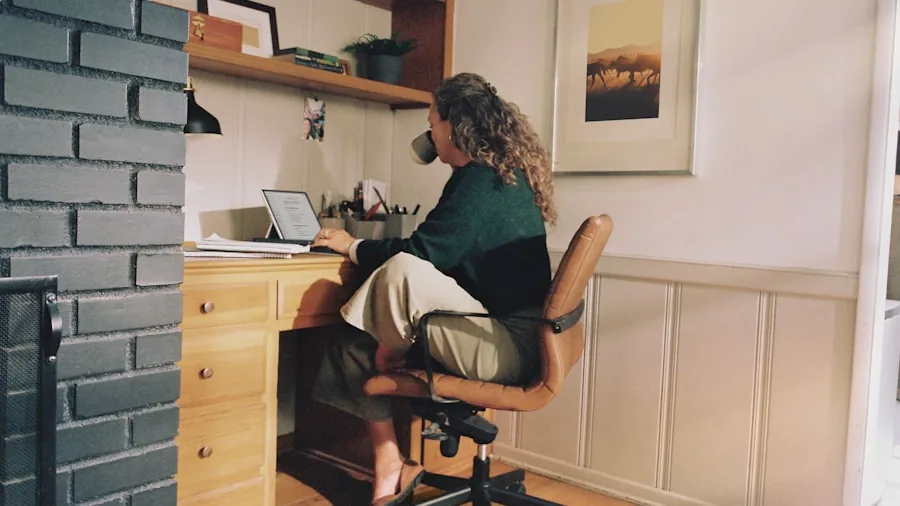 Person enjoying coffee during work session at desk with natural lighting