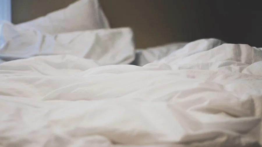The 11 Best Sheets 2 Person enjoying comfortable bedding on unmade bed in natural morning light