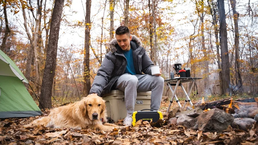 Person enjoying music on portable speaker during outdoor camping trip in nature