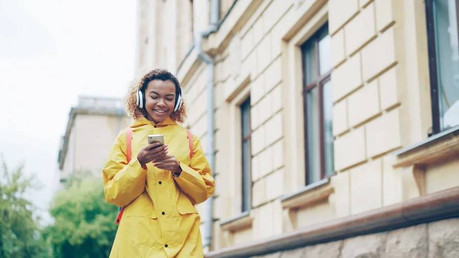 Person enjoying music with headphones in a natural outdoor setting, focused on audio experience