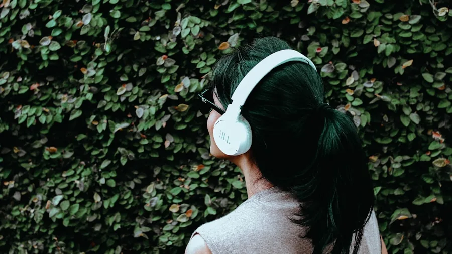 Person enjoying music with wireless headphones during a relaxed moment outdoors