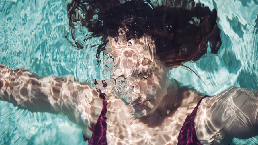 Person enjoying water activities with waterproof earbuds during swimming or water sports