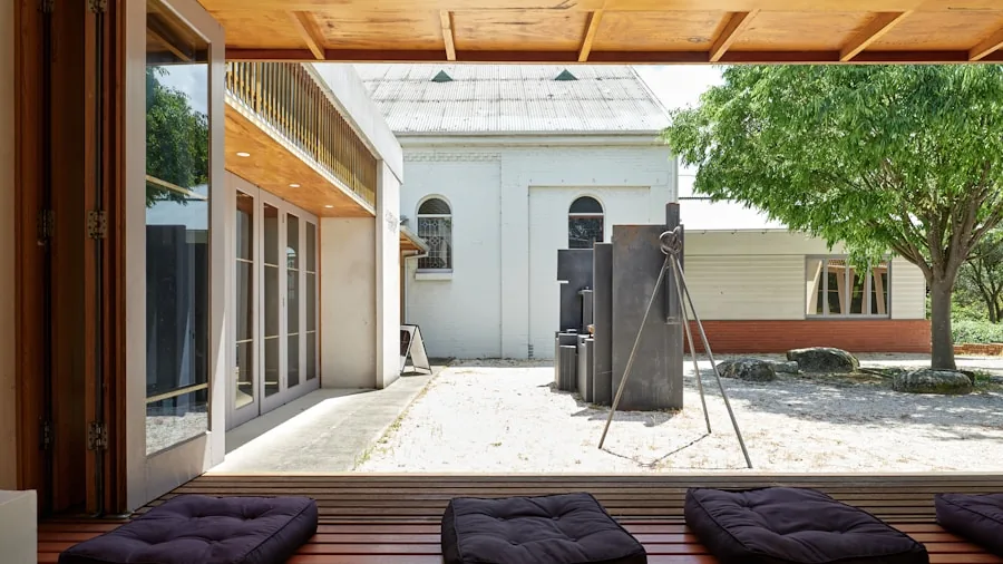 Person enjoying wireless speaker outdoors with stable Bluetooth connection in open garden space