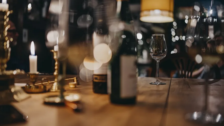 The %product_count% Best Wine Glasses 3 Person examining red wine in a glass at a table with natural lighting and wine accessories