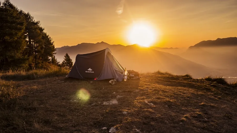 Person examining tent fabric quality and condition during outdoor camping trip in natural setting