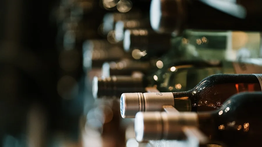 Person examining wine bottles at different temperatures in home wine storage area