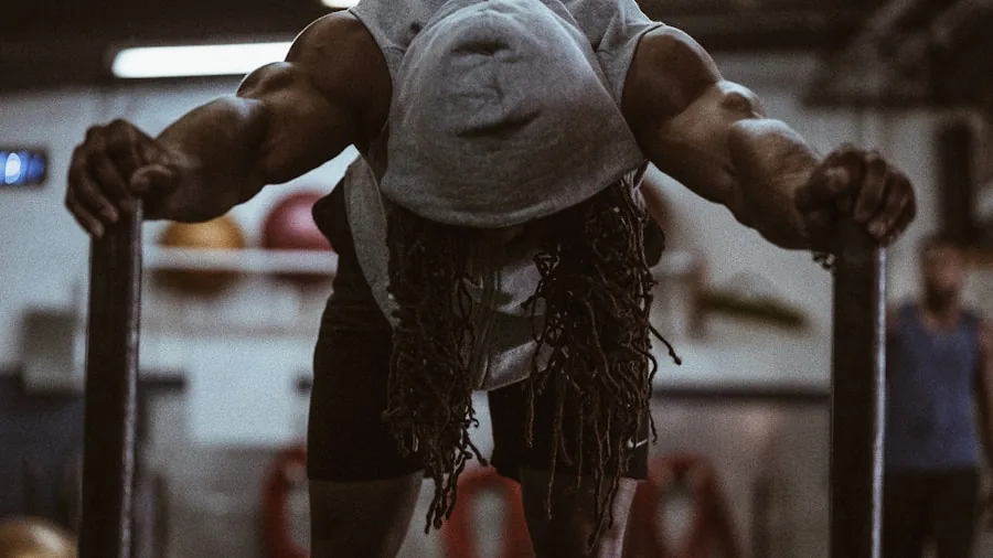 Person exercising with sweat on face during intense gym workout session