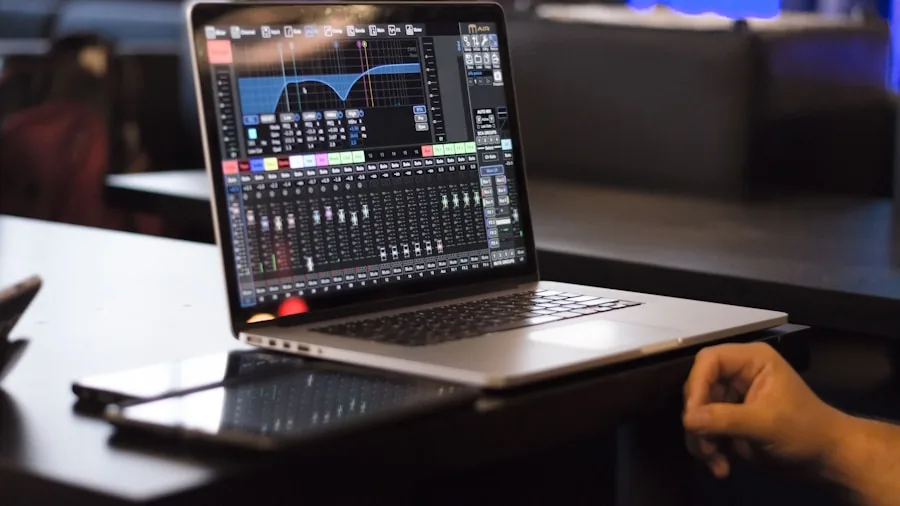 Person fine-tuning audio settings on laptop for gaming setup