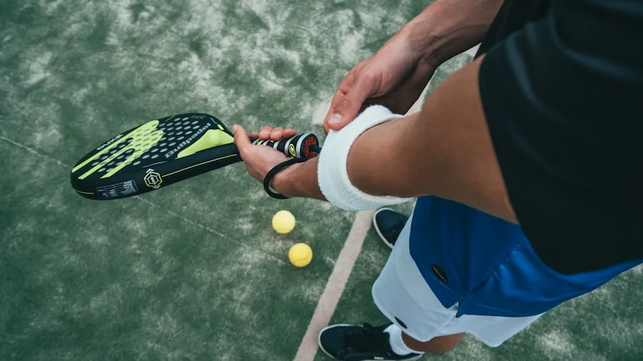 Person gripping a tennis racket during an outdoor match on a sunny day
