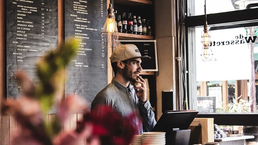Person having a phone call in a busy coffee shop environment with background noise