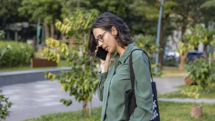 Person having a phone call outdoors in a natural environment