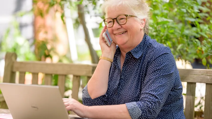 Person having a phone call outdoors in natural environment