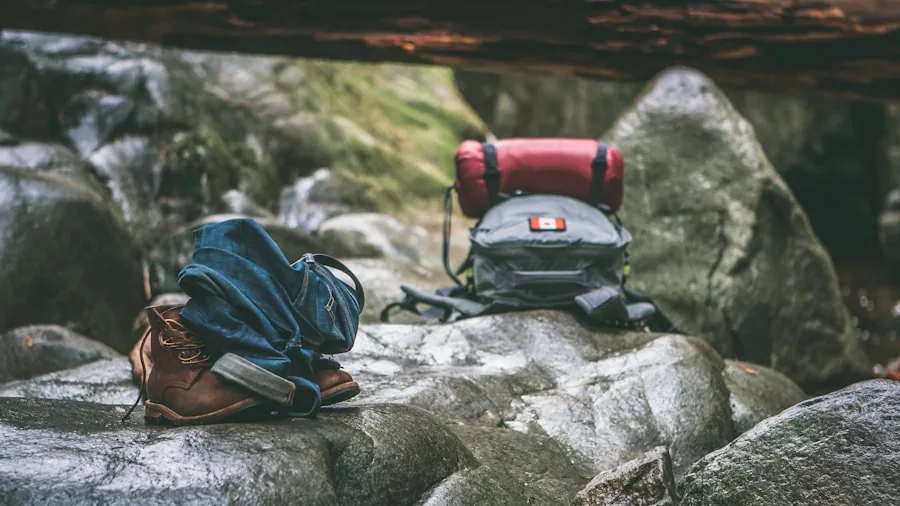 Person hiking on mountain trail with backpack and gear, demonstrating portable equipment for outdoor adventures