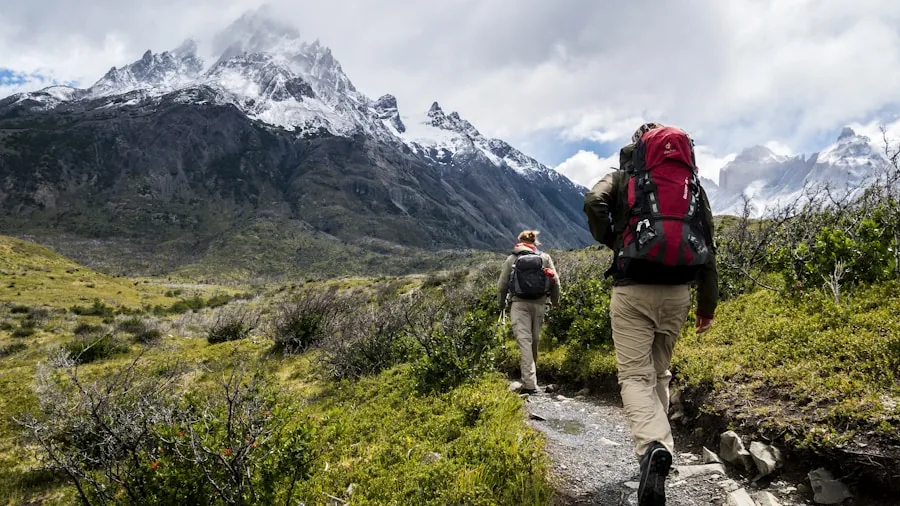 The %product_count% Best Hiking Pants 4 Person hiking uphill on sunny mountain trail wearing light breathable pants