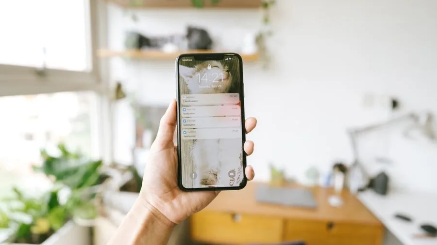 The %product_count% Best Budget Phones 6 Person holding smartphone while checking software updates and notifications on screen