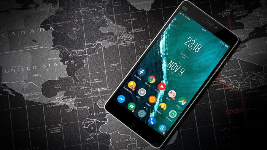 The %product_count% Best Smartphones 2 Person holding smartphone while reading content outdoors in natural daylight