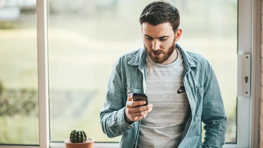 Person holding smartphone while working throughout the day, checking battery life and usage