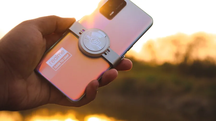 The %product_count% Best Phone Grips 5 Person holding smartphone with magnetic ring grip while taking photos outdoors
