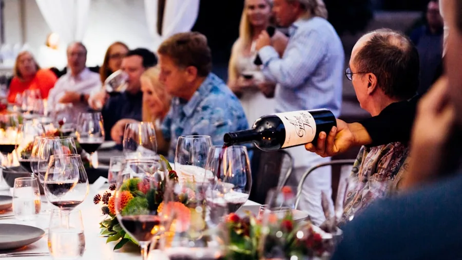 The %product_count% Best Wine Glasses 4 Person holding wine glass during meal at outdoor dining table