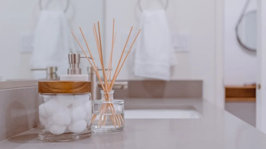 Person in bathroom preparing for daily wellness routine with morning essentials