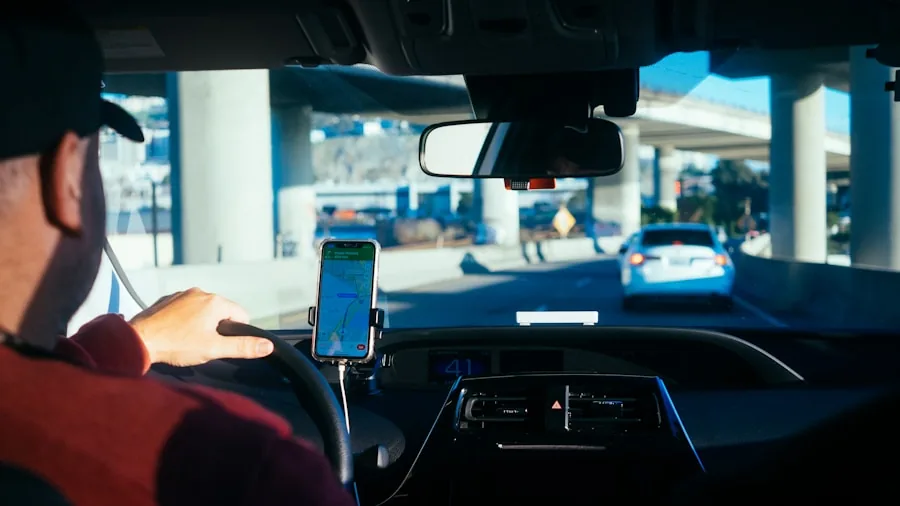 Person in car adjusting smartphone mount on dashboard during drive