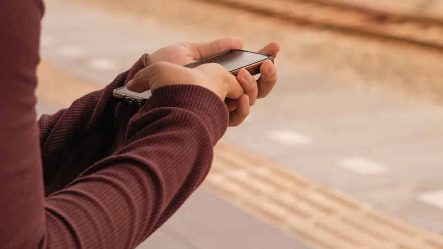 Person in casual setting checking smartphone battery level and device safety features