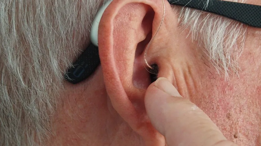 Person in garage wearing yellow ear protection while doing home improvement work
