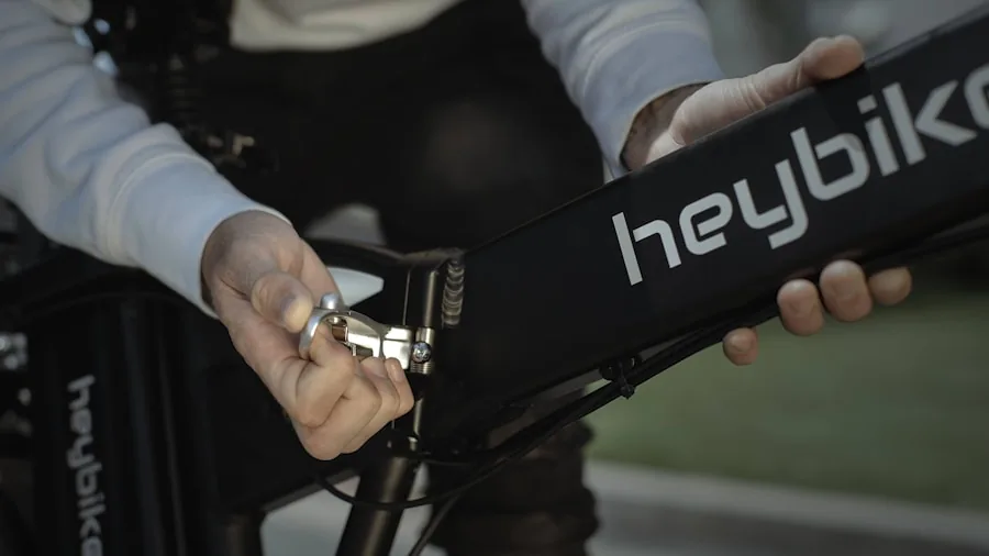 Person inspecting e-bike battery and safety features before riding