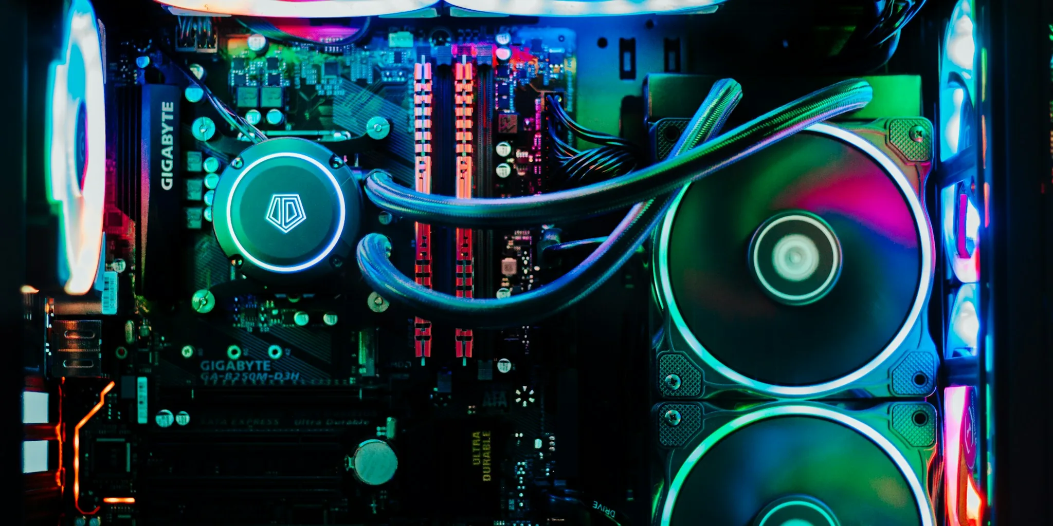 Person installing motherboard components inside computer tower during PC build setup
