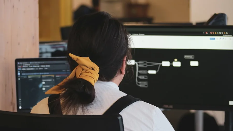Person intently monitoring computer performance metrics and stability tests on multiple displays during gaming setup optimization