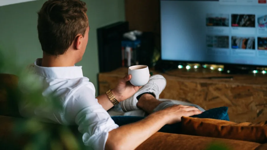 Person intently watching fast-paced sports action on a television screen from their living room