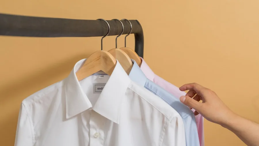 The 8 Best Ironing Boards 2 Person ironing white linens and clothing on ironing board in bright home laundry room
