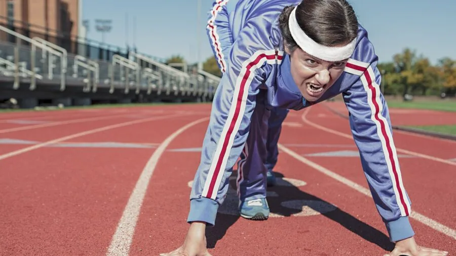 Person jogging outdoors wearing earbuds with secure fit and comfortable posture during active exercise
