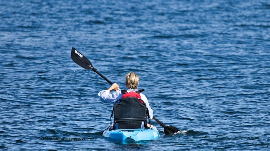 The %product_count% Best Kayaks for Fishing 6 Person kayaking on calm water during daytime, demonstrating open deck accessibility and outdoor fishing lifestyle