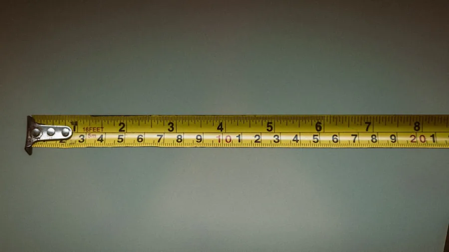 Person measuring bathroom wall with tape measure during home renovation project