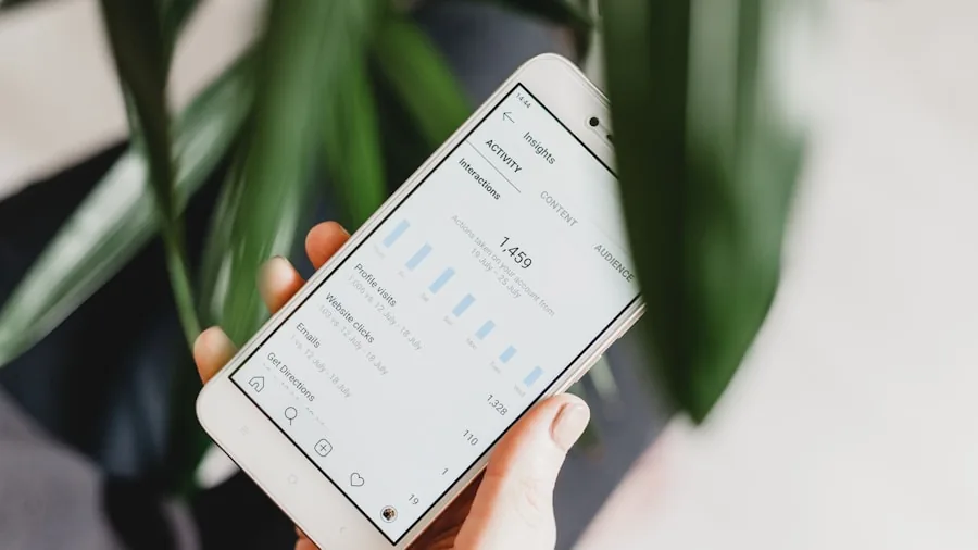 Person monitoring workout performance data on smartphone during exercise session
