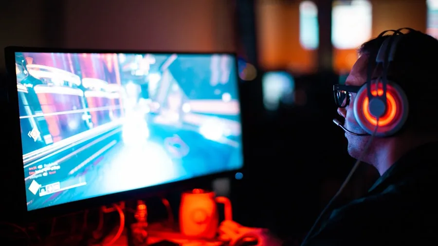 Person multitasking at gaming desk with multiple monitors and laptop during work session