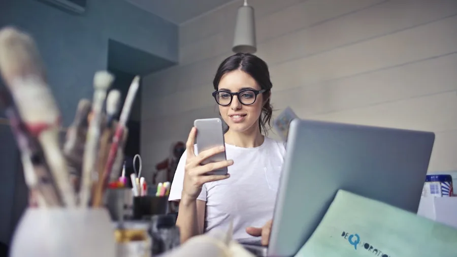 Person multitasking on mobile device while working, demonstrating processor performance and battery usage demands