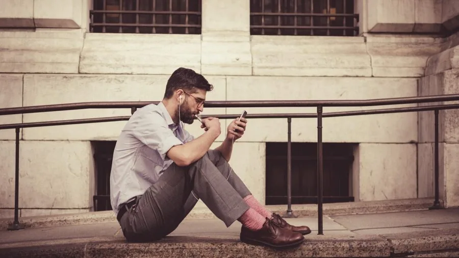 The %product_count% Best Smartphones 4 Person multitasking with smartphone during everyday activities, showing real-world mobile device usage