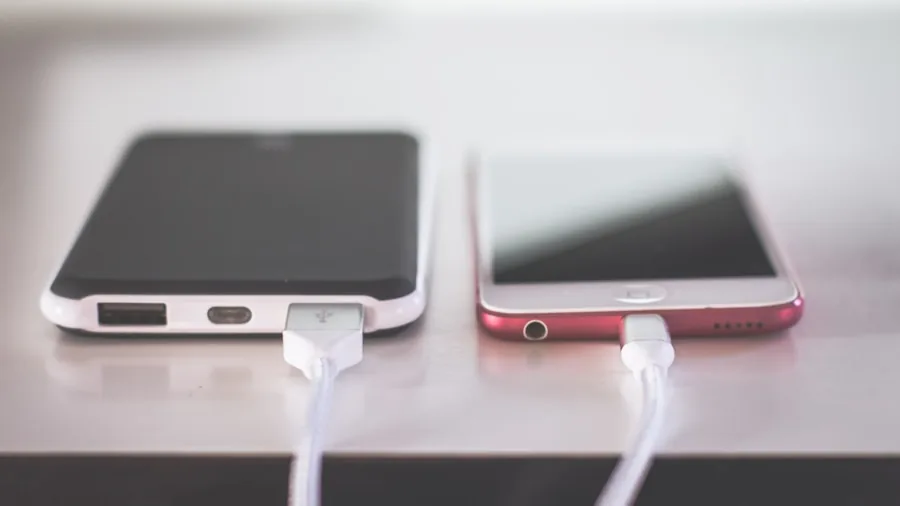 The %product_count% Best MagSafe Chargers 3 Person organizing and charging multiple tech devices on a desk in a modern home workspace