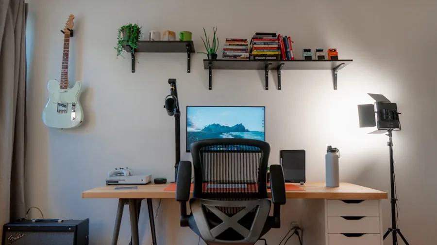Person organizing computer setup at desk with cables and equipment in home workspace