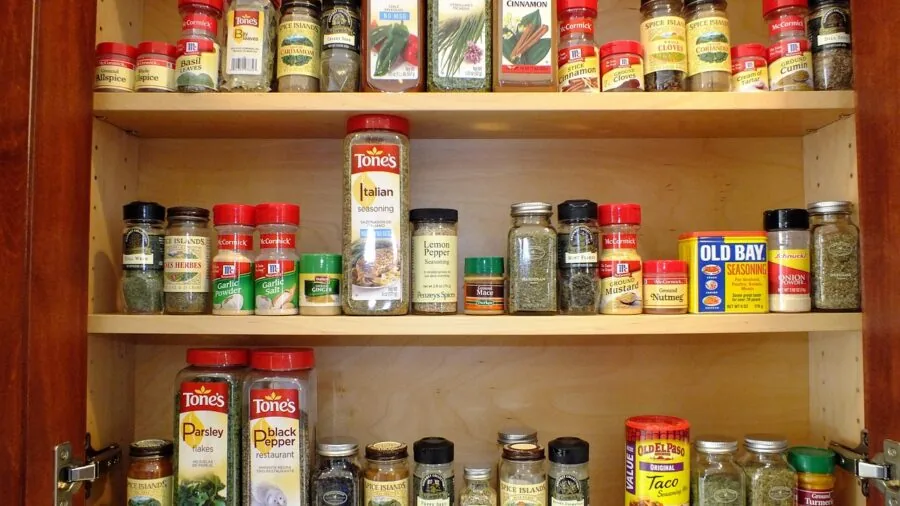 The %product_count% Best Storage Containers 4 Person organizing labeled storage containers in a bright kitchen pantry with various dry goods and supplies