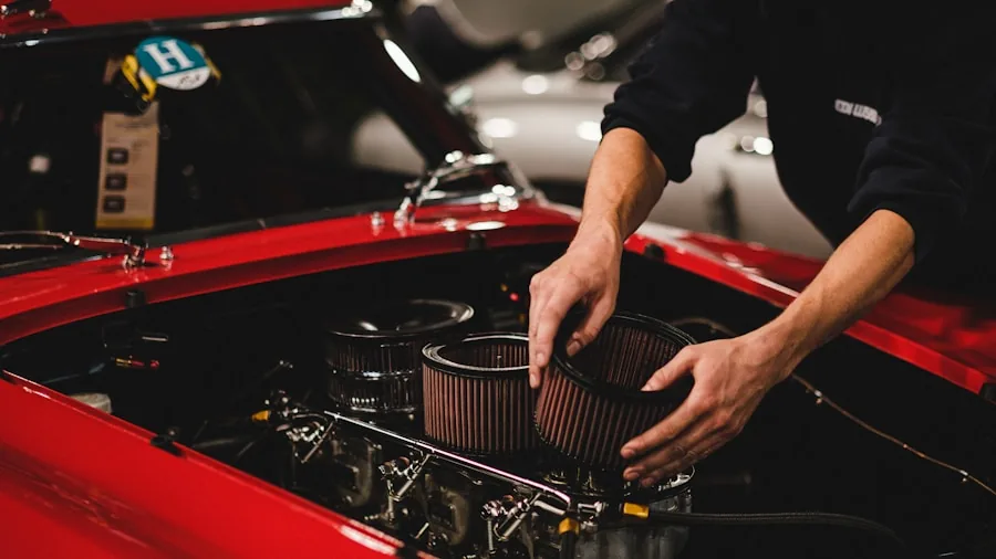 Person performing DIY car maintenance by replacing cabin air filter behind glove box with tools